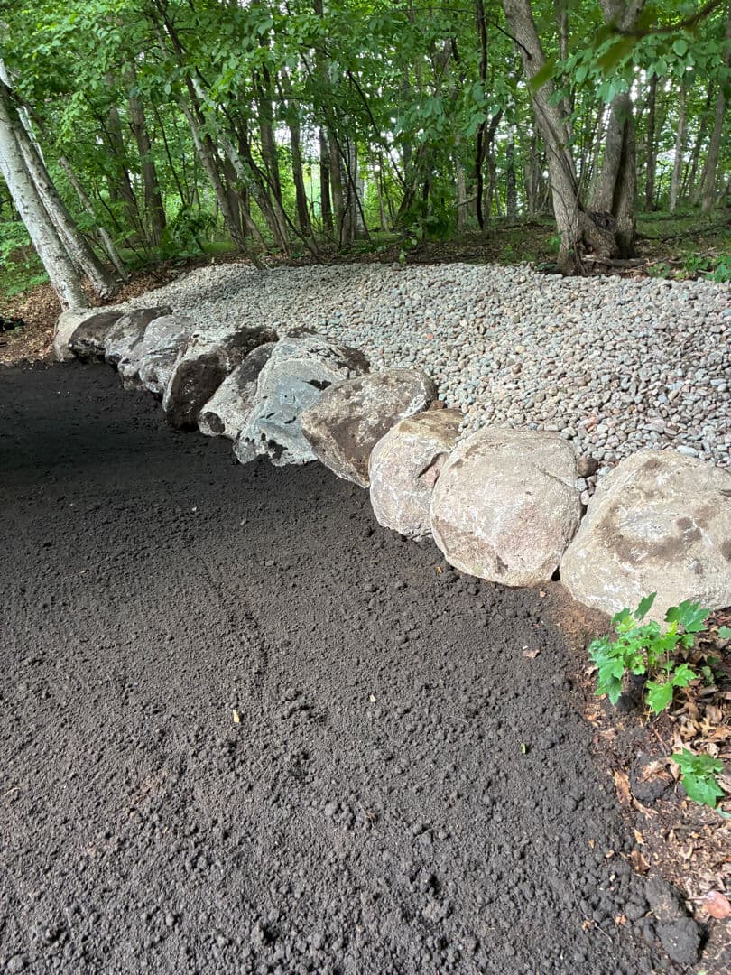 Boulder Edging and Gravel Work on a Sloped Property image